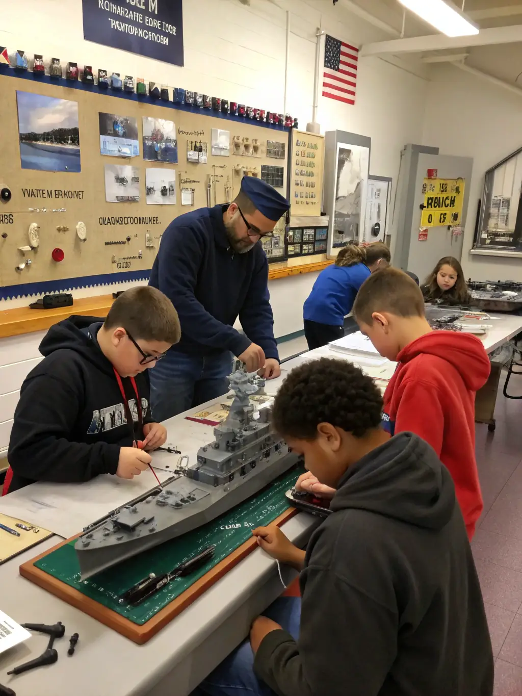 A classroom setting with children learning about maritime history and the significance of the Hermione.